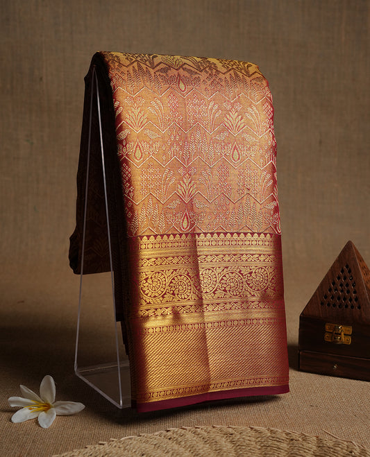 Red & gold double shade kancheepuram tissue silk saree highlighting gold floral zari pattern body, with contrast burgundy colour colour with kodi traditional border and paired with matching blouse.