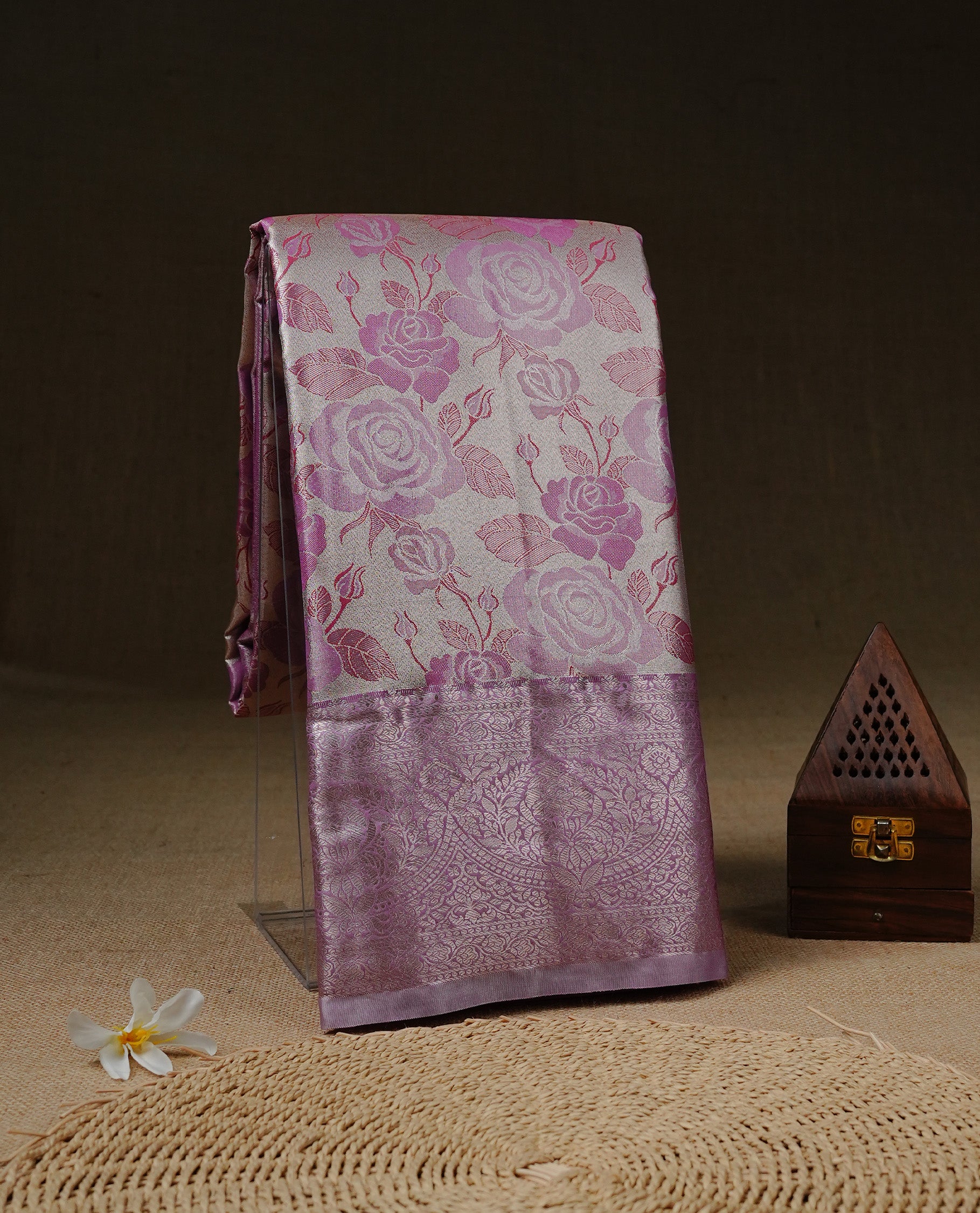 Light Gold colour Tissue silk saree featuring Pink colour floral zari motifs on body, complemented by contrast Lavender with Gold zari border, paired with matching blouse piece.