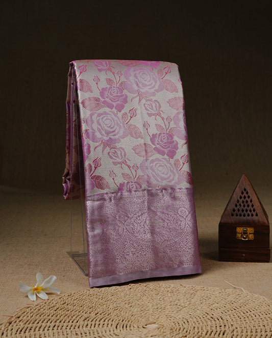 Light Gold colour Tissue silk saree featuring Pink colour floral zari motifs on body, complemented by contrast Lavender with Gold zari border, paired with matching blouse piece.