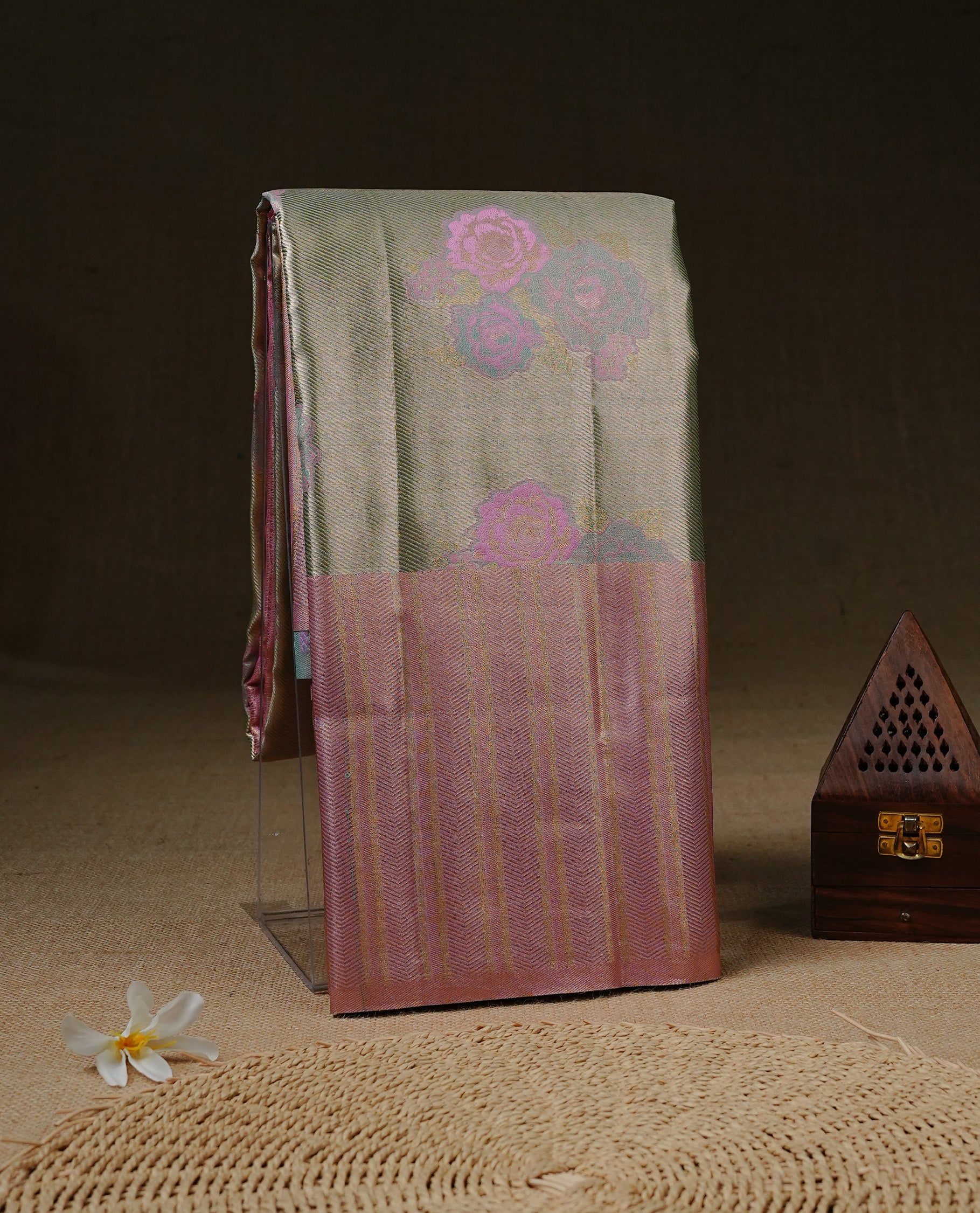 Golden green colour Tissue silk saree featuring Pink colour floral zari motifs on body, complemented by contrast Light Pink zari border, paired with matching blouse piece.