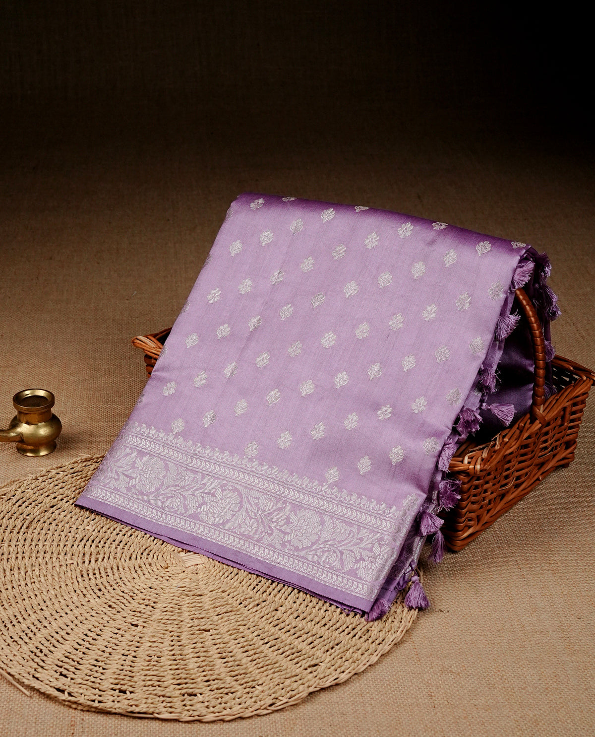 Light purple colour banaras sare featuring silver zari buttas on body, complemented silver zari on self colour border, comes with matching blouse piece.