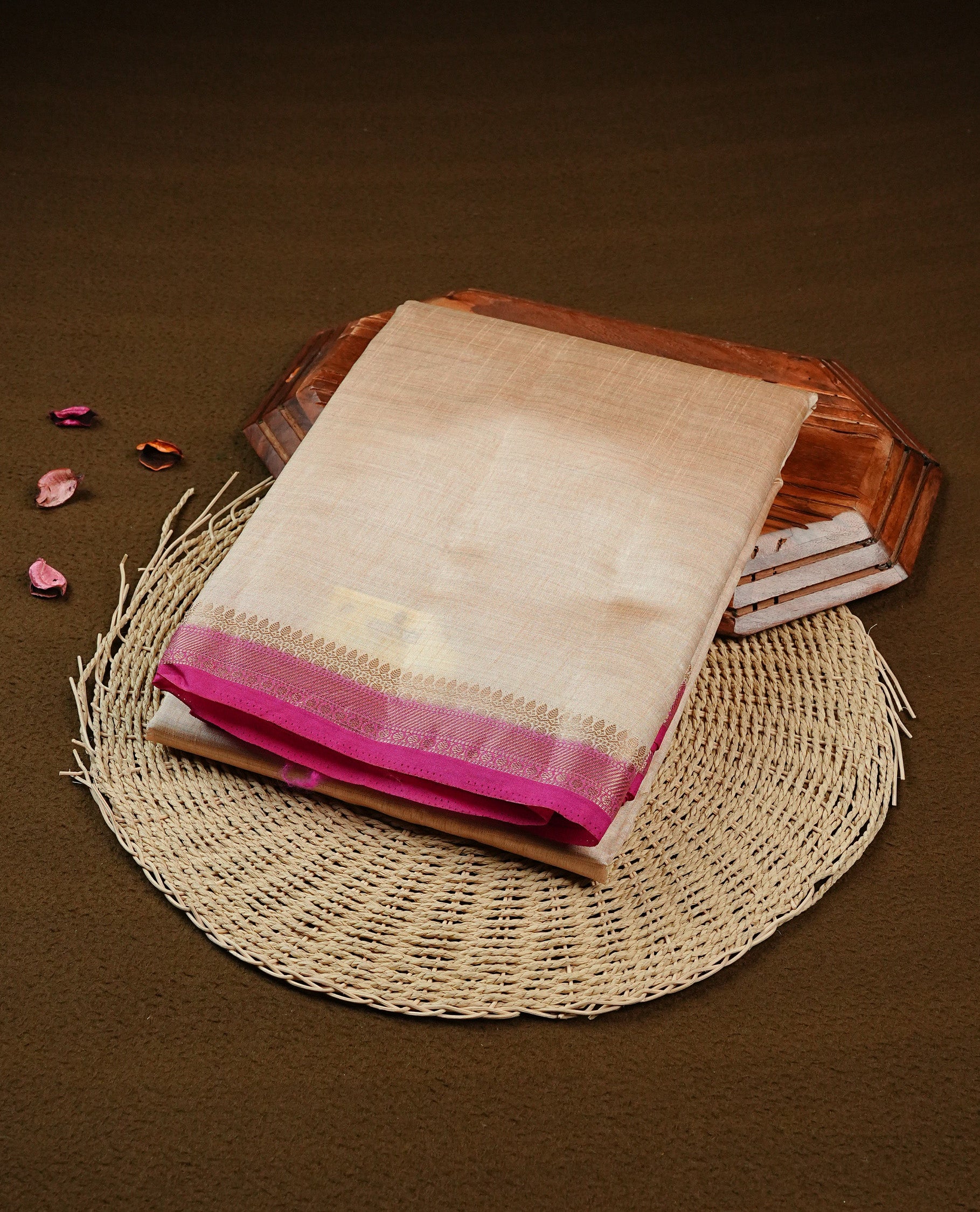 Light gold Colour Tussar saree featuring elegant plain body, complemented by contrast Magenta colour with zari work border, comes with matching blouse piece.