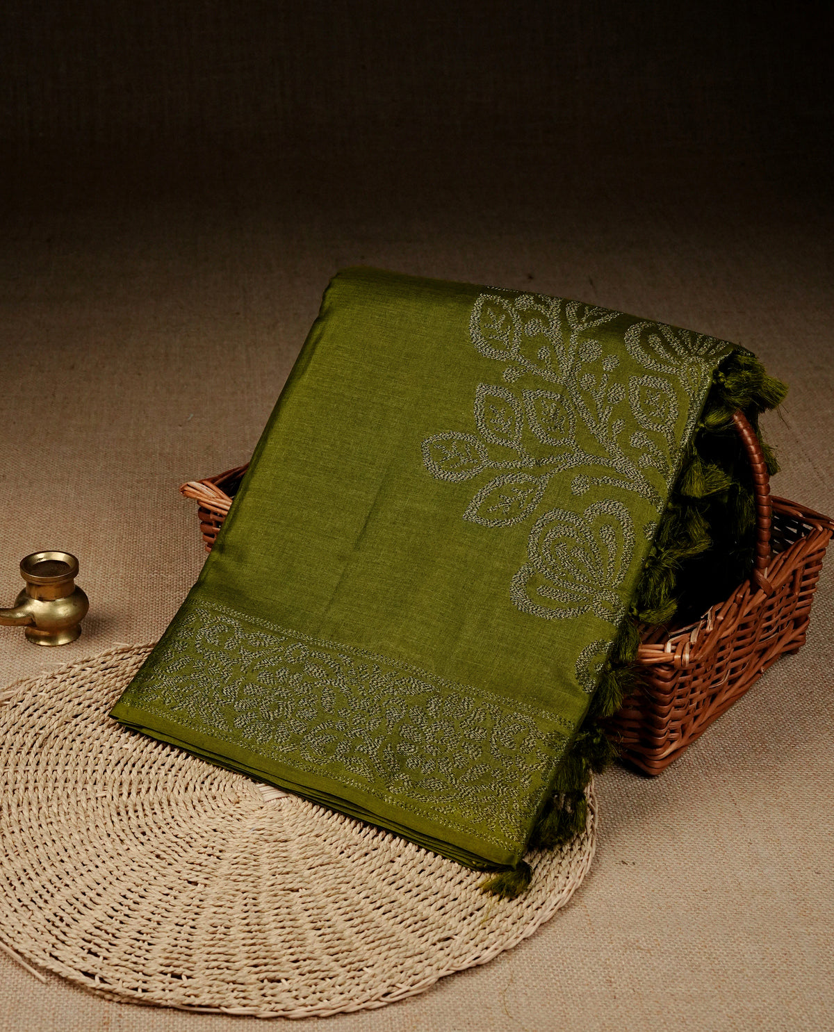 Olive colour banaras saree featuring Antique zari kodi pattern on body, complemented by Zari pattern on self colour border, comes with matching blouse piece.