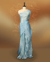 Pastel Blue colour crush soft silk saree adorned with bold floral thread embroidery on the body and scallop edged borders, Paired with a matching blouse for a complete look.