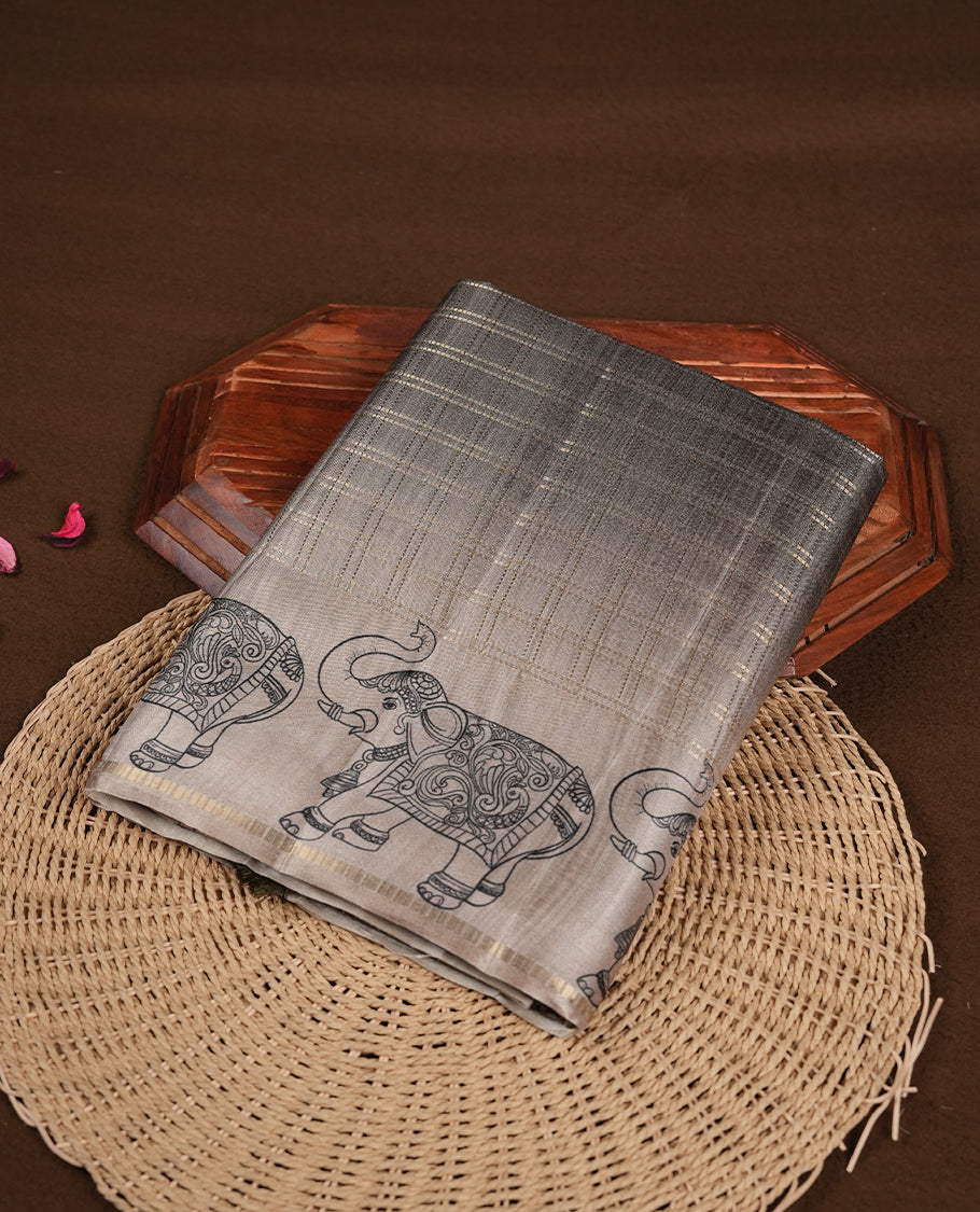 Green colour semi tusser silk saree featuring Gold zari check pattern across body, faded contrast cream colour border with elephant print and paired with matching blouse.