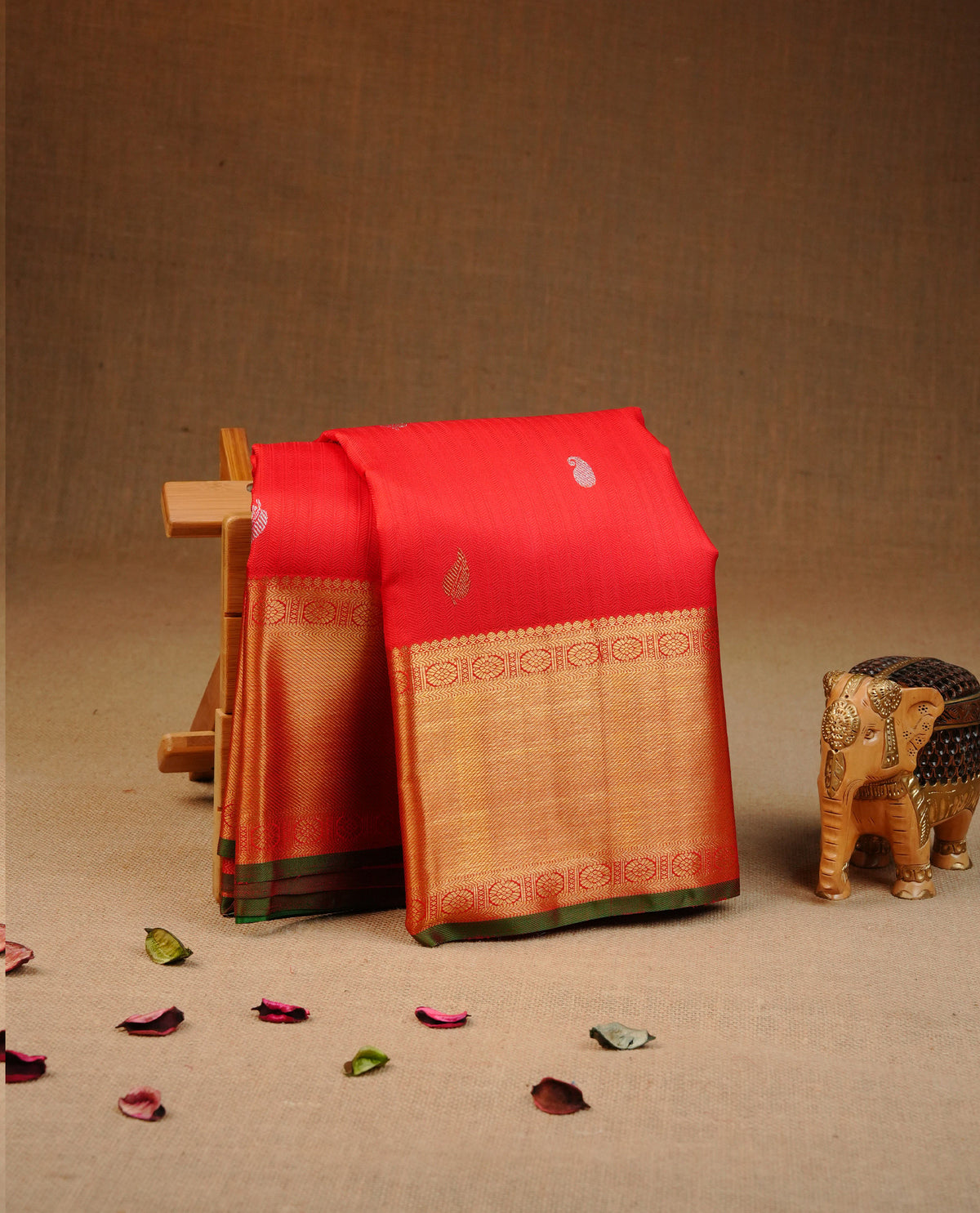 Red colour Traditional kancheepuram silk saree featuring Self colour design body with gold & silver zari buttas, complemented by Self colour with traditional border and green piping , comes with matching blouse piece.