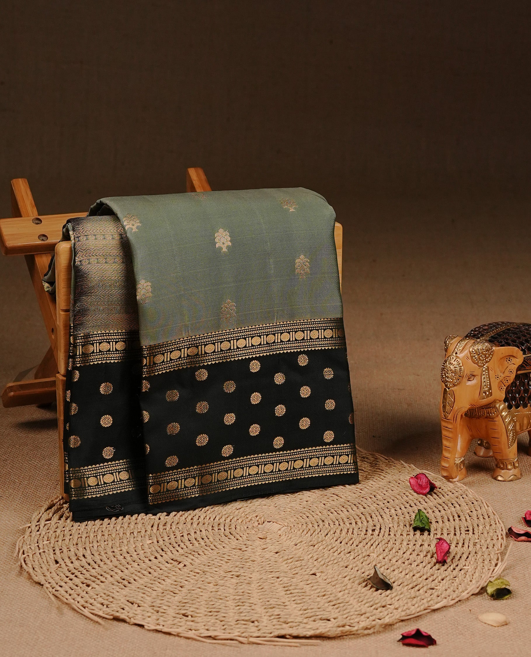 Dark Sea Green colour Traditional Kancheepuram silk saree featuring gold zari motifs on body, enhanced with contrast Dark green with traditional border, paired with matching blouse piece.