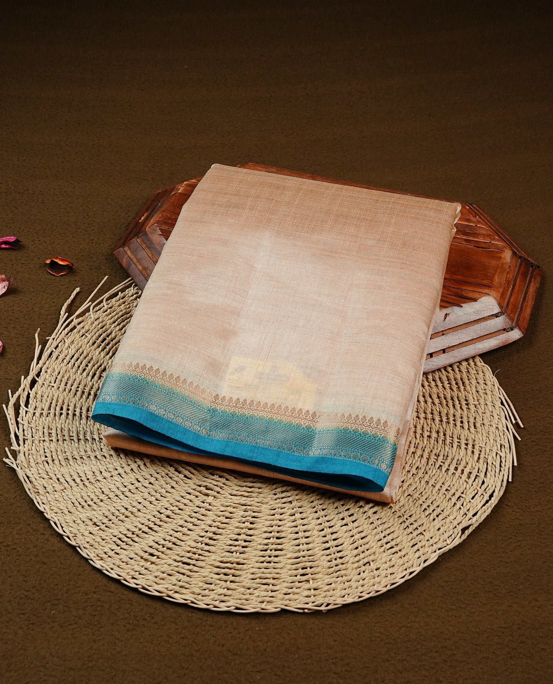 Light gold Colour Tussar saree featuring elegant plain body, complemented by contrast Blue colour with zari work border, comes with matching blouse piece.