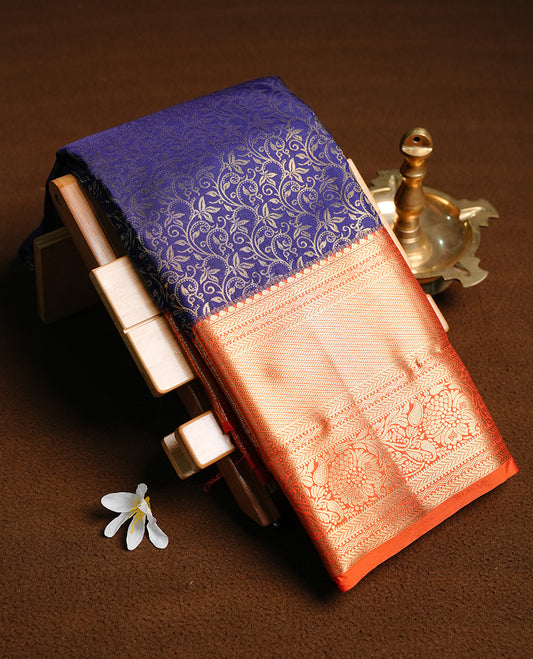 Magenta colour semi wedding saree featuring gold zari floral kodi pattern on body, complemented by contrast chocolate with traditional border, paired with matching blouse piece.