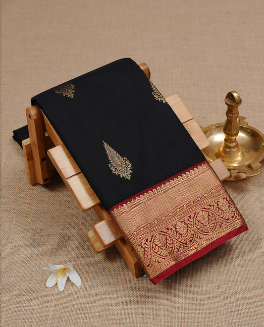 Black colour semi Wedding silk saree featuring Gold zari motifs on body, enhanced with Contrast red colour with traditional border, paired with matching blouse piece.