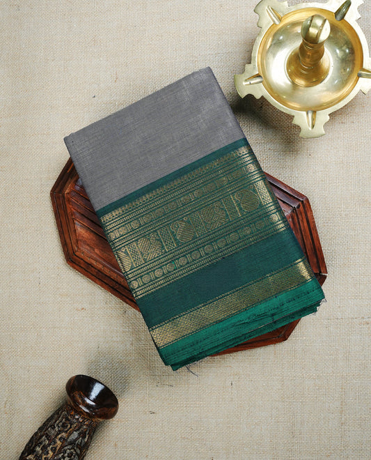 Grey  colour chettinad cotton saree featuring  Plain body, complemented by  Green Colour With Gold Zari border, paired with matching blouse piece.