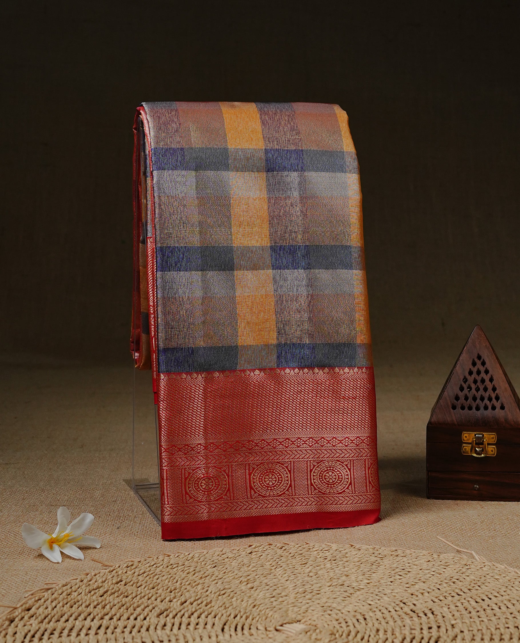 Blue & Yellow Colour Tissue Saree featuring Multi colour Check Design on body, complemented by contrast Red colour with Gold zari border, paired with matching blouse piece.