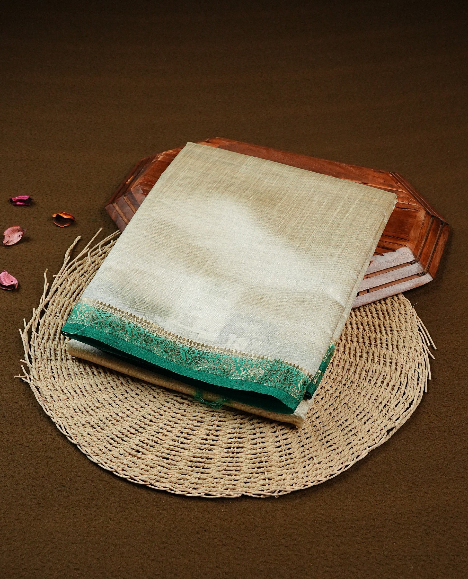 Light gold Colour Tussar saree featuring elegant plain body, complemented by contrast green colour with zari work border, comes with matching blouse piece.