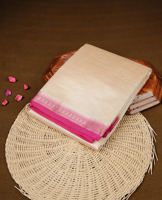 Cream colour Semi Tussar silk saree featuring an elegant plain body, accentuated by a contrast Pink border adorned with intricate gold Mango zari work, paired with a matching blouse piece.