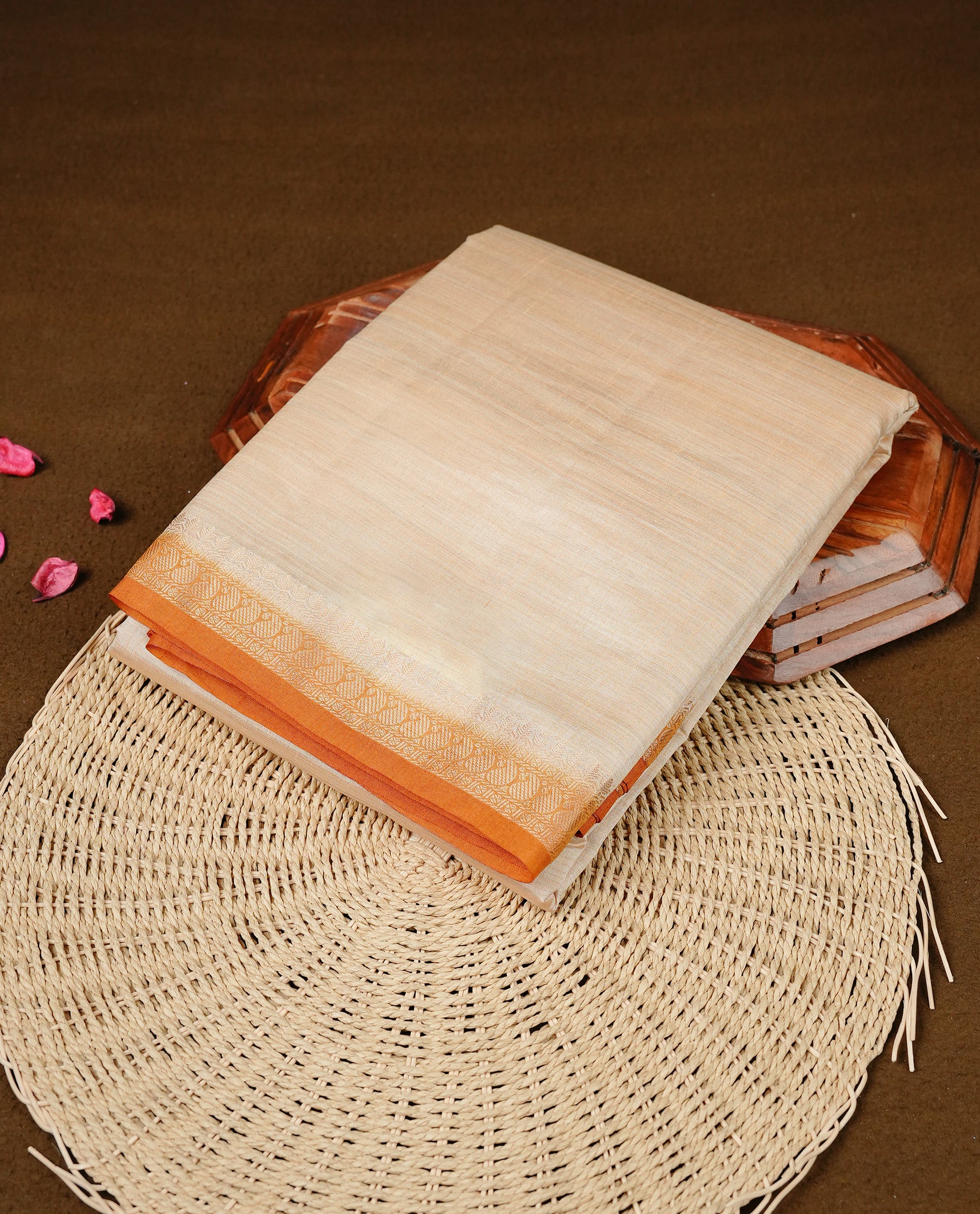Cream colour Semi Tussar silk saree featuring an elegant plain body, accentuated by a contrast mustard border adorned with intricate gold Mango zari work, paired with a matching blouse piece.