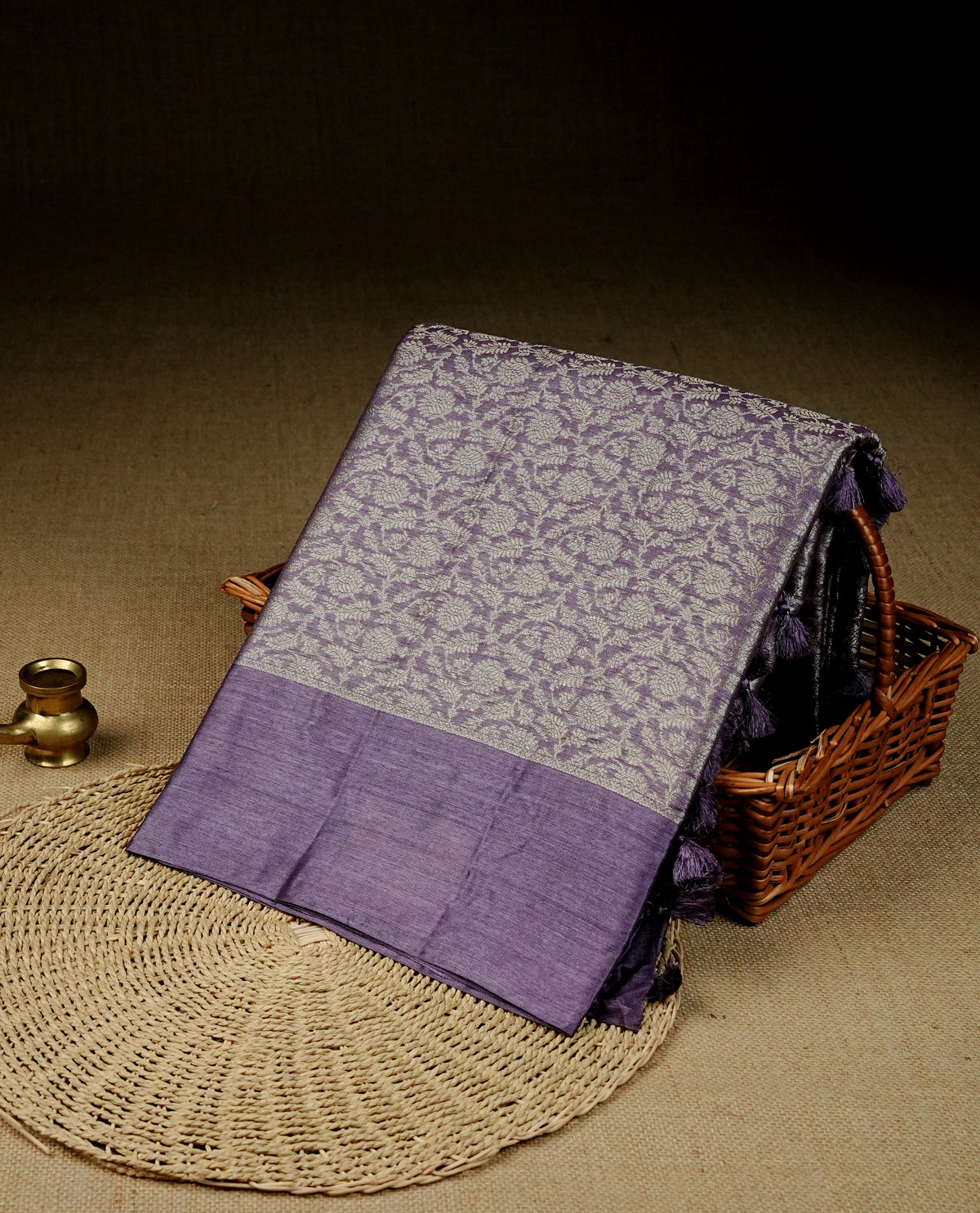 Pastel purple Colour banaras saree featuring Light gold zari Floral kodi pattern on body, complemented by borderless finish, comes with matching blouse piece.