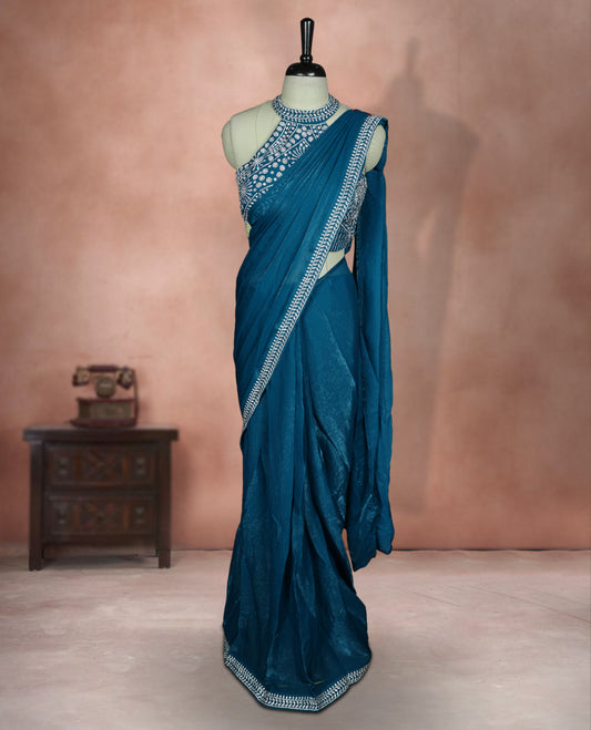 Elegant Aqua blue colour ready to wear saree adorned with rich white stone embroidery along the border and pallu, paired with a heavily embellished matching blouse for a grand festive look.