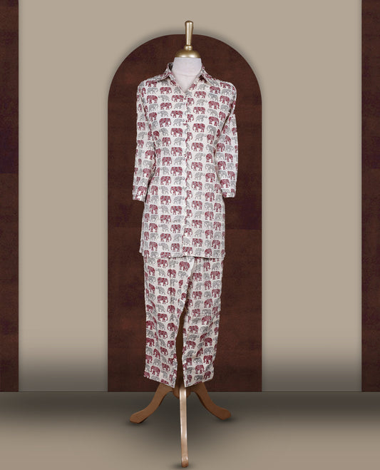 Off white colour cotton coord set featuring charming elephant prints all over, Designed with a classic shirt collar and 3/4 sleeves, paired with matching straight pants for a trendy, relaxed, and comfy everyday look.