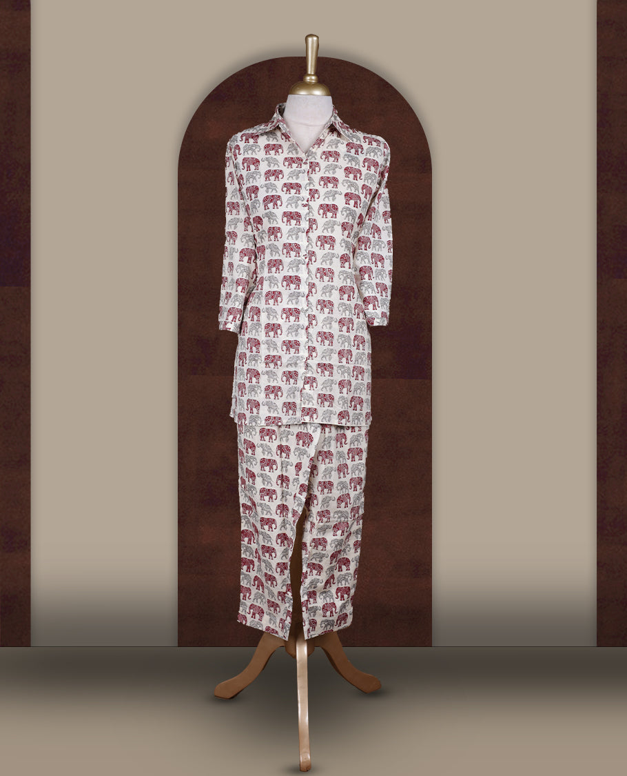 Off white colour cotton coord set featuring charming elephant prints all over, Designed with a classic shirt collar and 3/4 sleeves, paired with matching straight pants for a trendy, relaxed, and comfy everyday look.