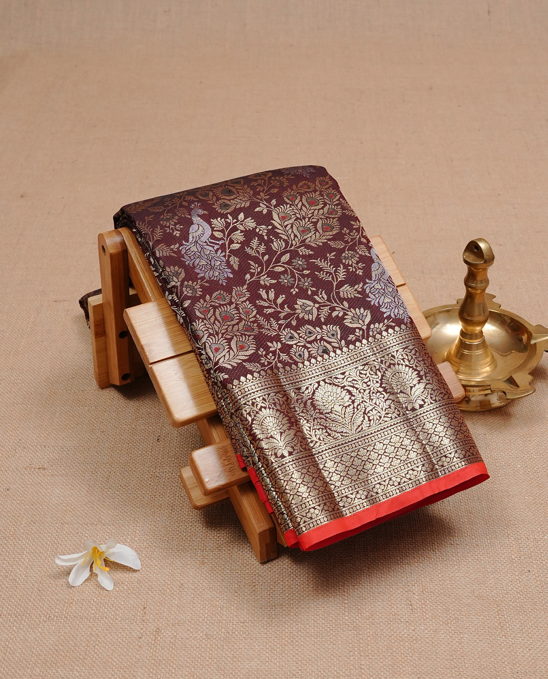 Dark chocolate colour semi wedding silk saree featuring Gold zari Floral kodi pattern with Silver zari peacock motifs on body, complemented gold zari border, paired with matching blouse piece.