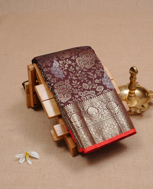 Dark chocolate colour semi wedding silk saree featuring Gold zari Floral kodi pattern with Silver zari peacock motifs on body, complemented gold zari border, paired with matching blouse piece.