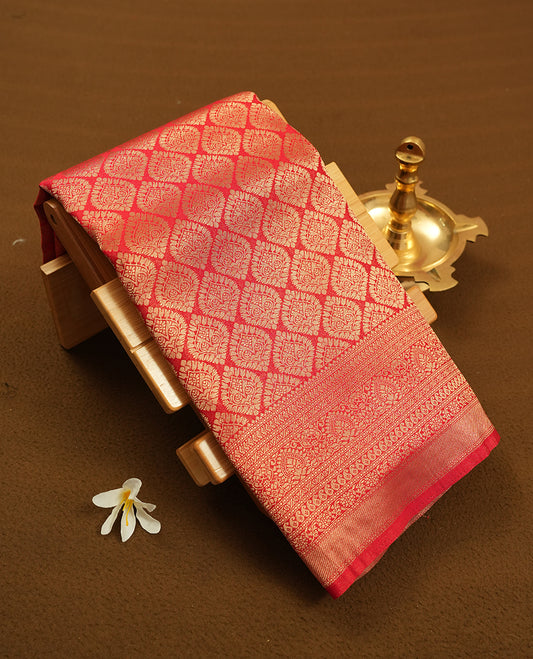 Red colour semi silk brocade saree featuring intricate Gold butta patterns across the body, complemented by a rich self colour woven border and pallu, paired with a matching blouse.