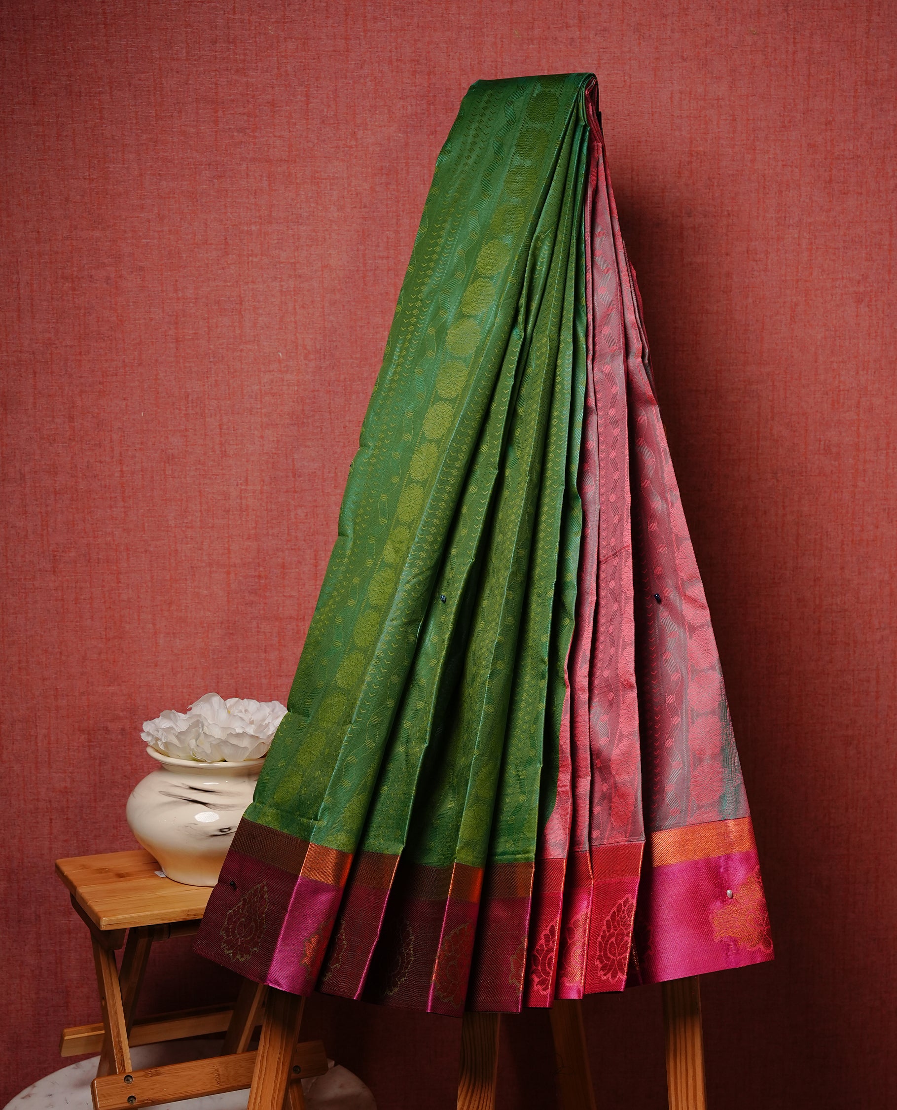 Green colour Semi silk saree Featuring Selfcolour zari Pattern on body, complemented by Contrast magenta colour with gold zari border, paired with matching blouse piece.