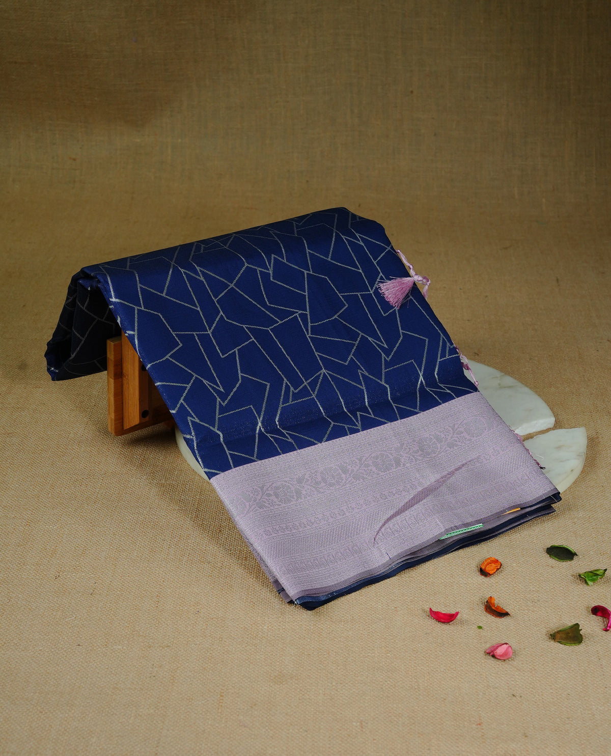 Navy blue colour semi silk saree featuring Silver zari Geometric pattern on body, complemented by contrast Pink colour with silver zari border, comes with matching blouse piece.