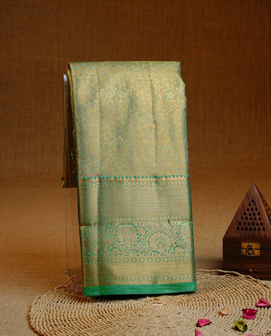 Green & Gold double shade colour Semi tissue silk saree featuring gold zari kodi floral motifs on body, Contrast Green colour with traditional border, paired with matching blouse piece.
