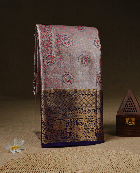 Pink colour tissue silk saree featuring Gold, Blue & silver zari kodi pattern on body, complemented by contrast violet colour with traditional border, paired with matching blouse piece.