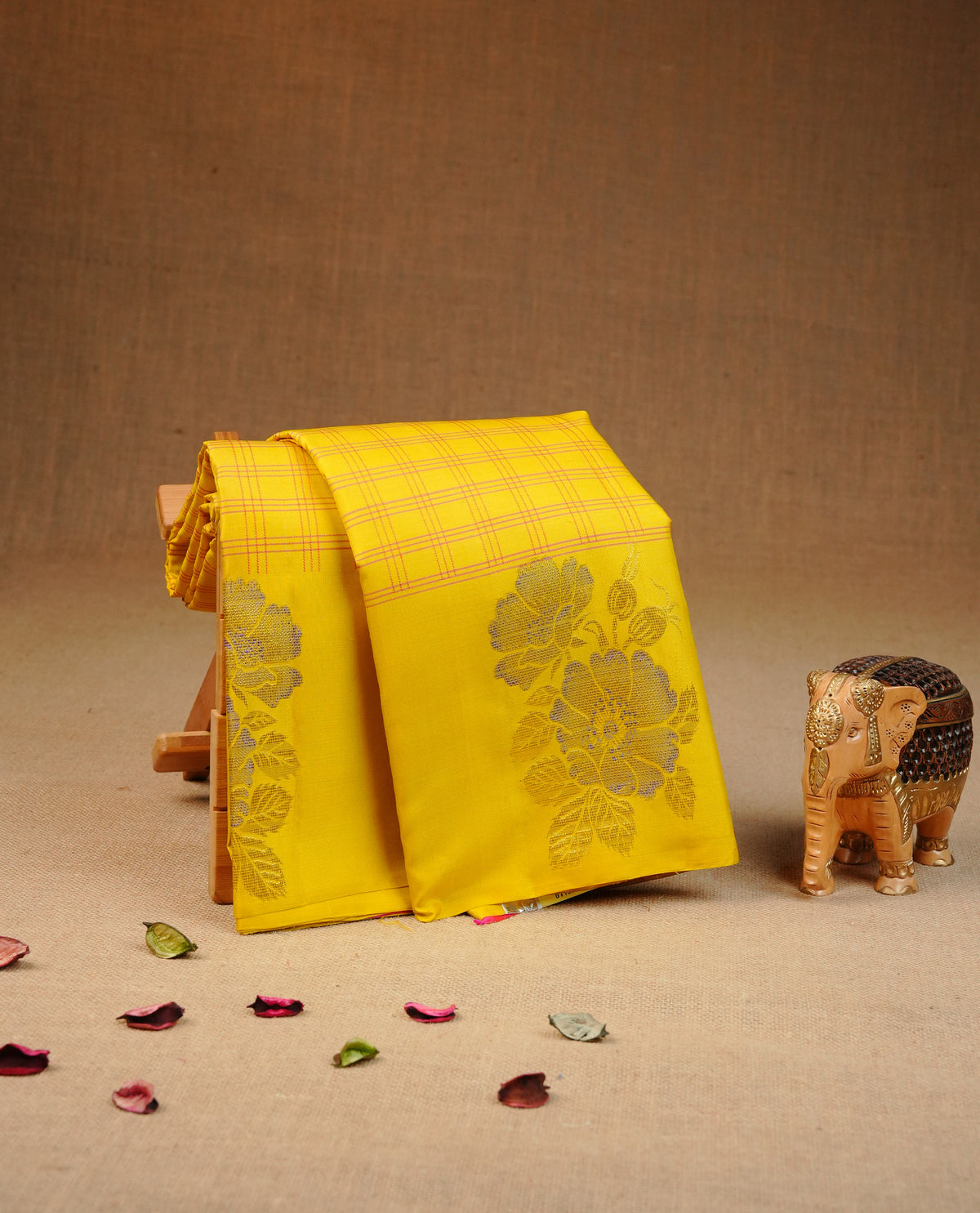 Yellow colour Traditional kancheepuram silk saree featuring Pink zari check on body, complemented by self colour with Gold & Blue zaro floral motifs on border, comes with matching blouse piece.