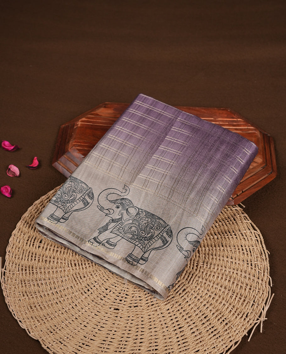 Purple colour semi tusser silk saree featuring Gold zari check pattern across body, faded contrast cream colour border with elephant print and paired with matching blouse.