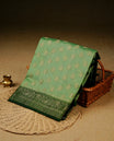 Pista green colour banaras silk saree featuring gold zari buttas on body, complemented by contrast Dark green with gold zari border, comes with matching blouse piece.