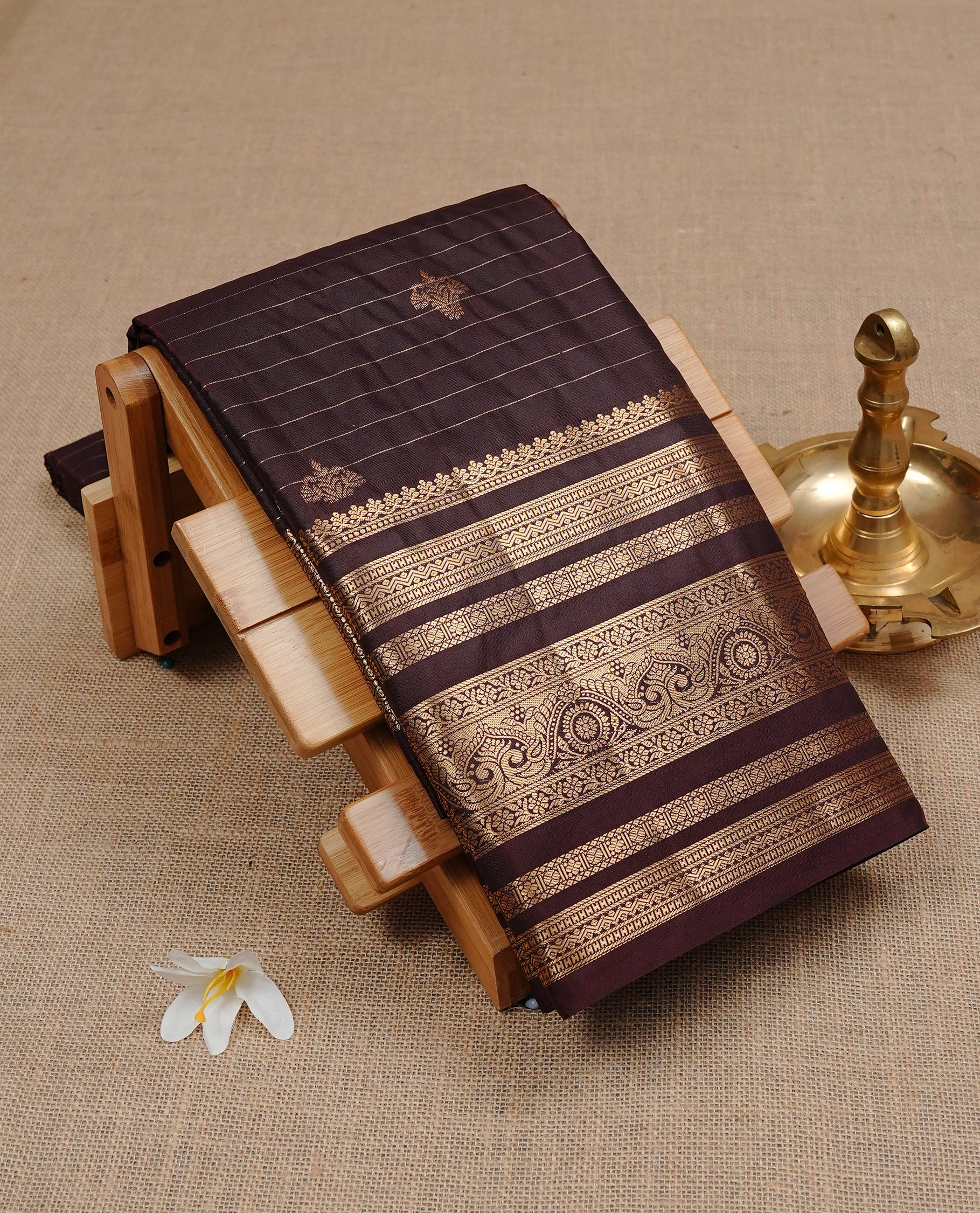 Dark Chocolate Colour Wedding Silk Saree Featuring Gold zari stripes on body, complemented by traditional Zari pattern on self colour border, paired with matching blouse piece.