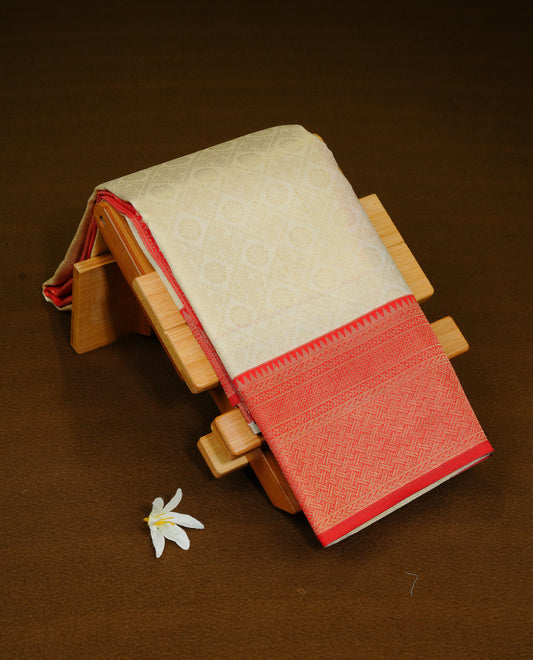 Cream Colour Semi Soft Silk Saree Featuring Gold zari Box With motifs Pattern On Body, Highlighted  by contrast Red border with Gold zari, paired with matching blouse piece.