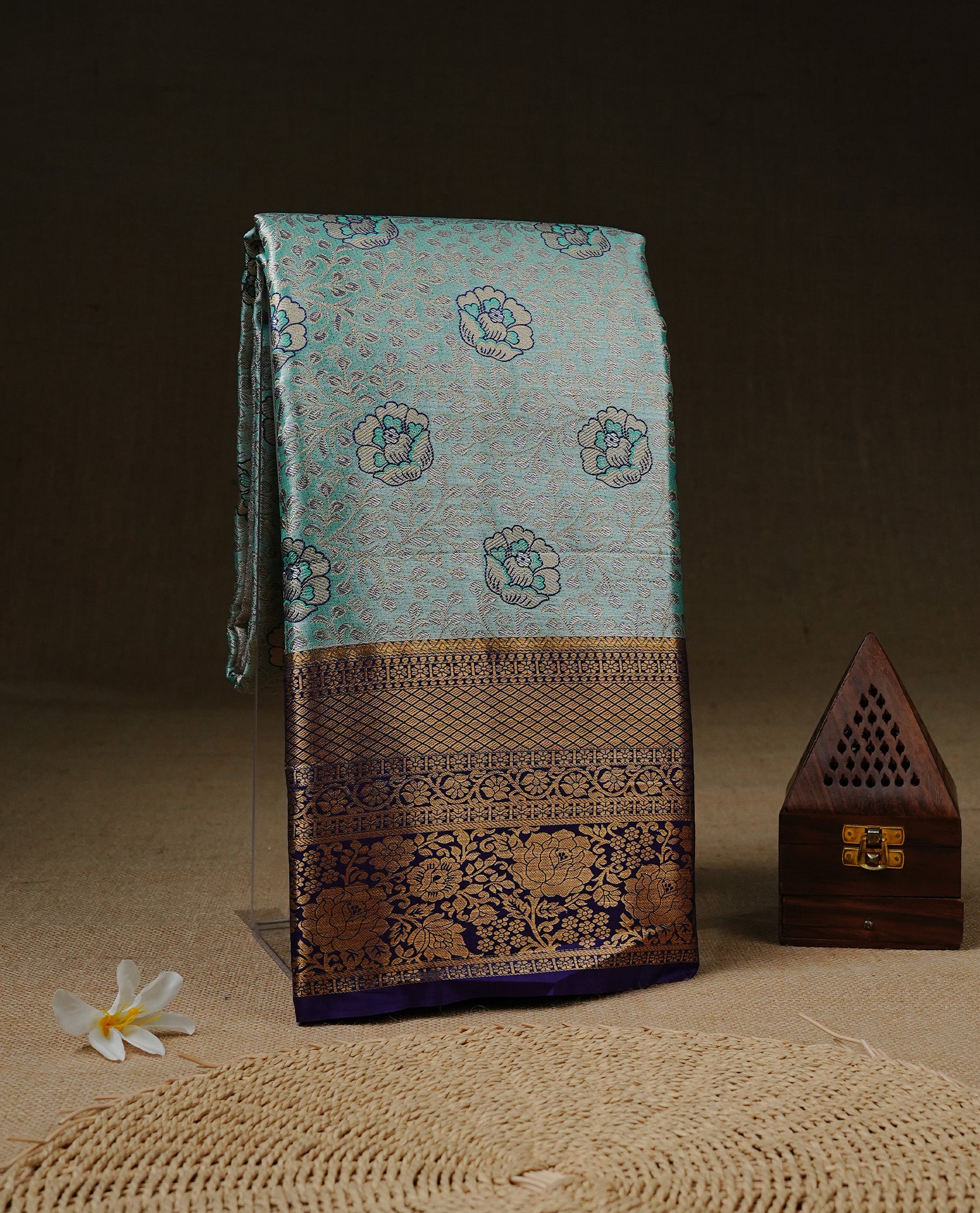 Aqua green colour and antique gold Zari Tissue Brocade Saree features intricate floral Motifs on body and rich Violet colour with traditioal Border & pallu with Gold Zari Patterns paired with matching blouse