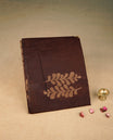 Dark Brown colour semi silk saree featuring Gold zari Leaf pattern on body, complemented by contrast colour with Gold zari border, comes with matching blouse piece.