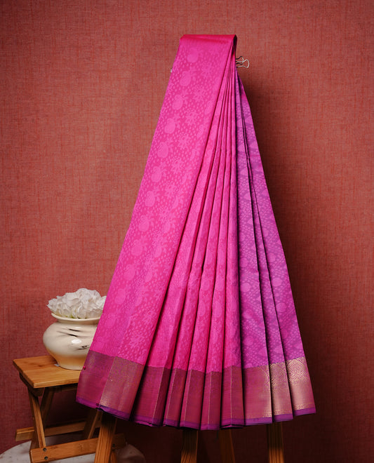 Bright Pink colour Semi silk saree Featuring Self colour zari motifs on body, complemented by contrast purple colour with gold zari border, paired with matching blouse piece.