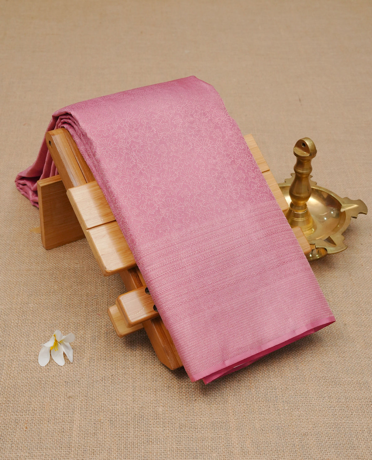 Baby pink colour pure wedding silk saree featuring Light gold zari Floral kodi pattern on body, complemented by self colour with traditional border, comes with matching blouse piece.