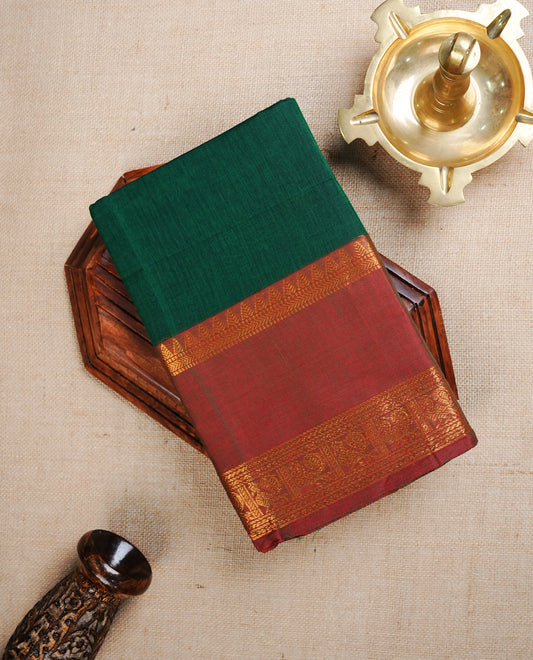 Green colour Chettinad cotton saree featuring Elegant plain body, Complemented by contrast Brown with gold zari border, paired with matching blouse piece.