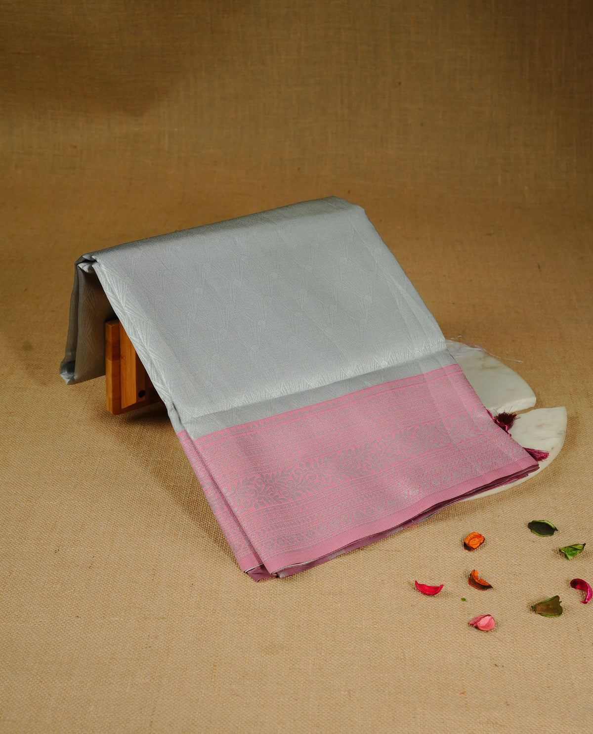 Grey colour semi silk saree featuring Silver zari Design pattern on body, complemented by contrast Pink colour with silver zari border, comes with matching blouse piece