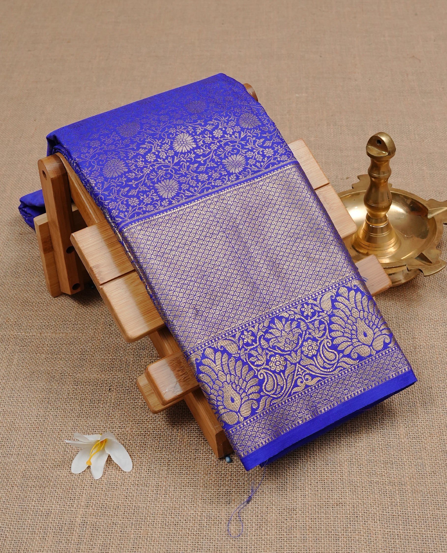Indigo Colour Wedding Silk Saree Featuring Gold zari Floral kodi pattern on body, complemented by traditional Zari pattern on self colour border, paired with matching blouse piece.