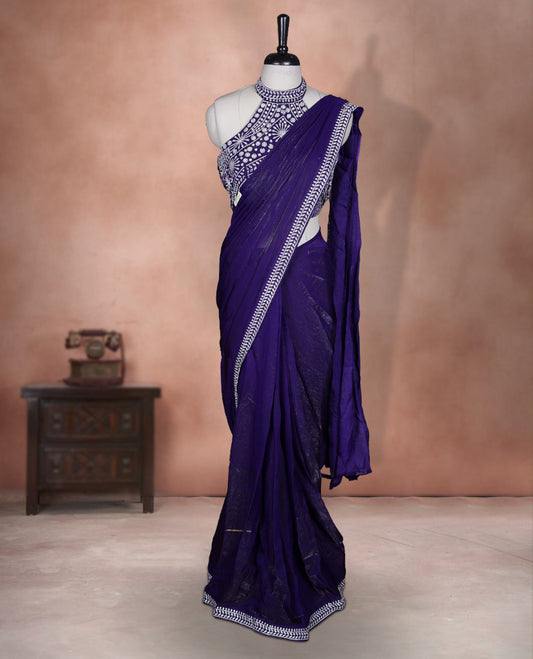 Elegant Dark purple colour ready to wear saree adorned with rich silver stone embroidery along the border and pallu, paired with a heavily embellished matching blouse for a grand festive look.