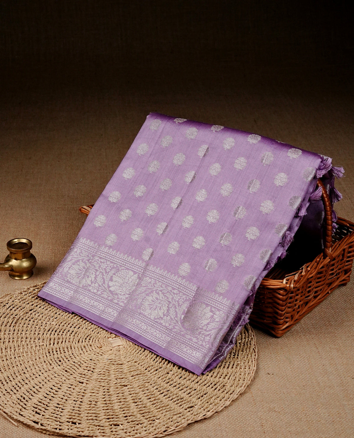 Light Purple colour banaras saree featuring silver zari buttas on body, complemented silver zari on self colour border, comes with matching blouse piece.