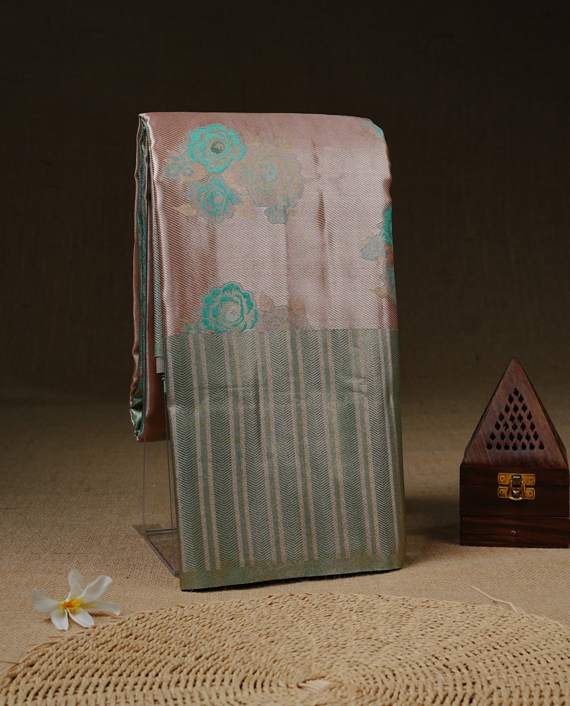 Light Pink colour Tissue silk saree featuring Green colour floral zari motifs on body, complemented by contrast Light green zari border, paired with matching blouse piece.