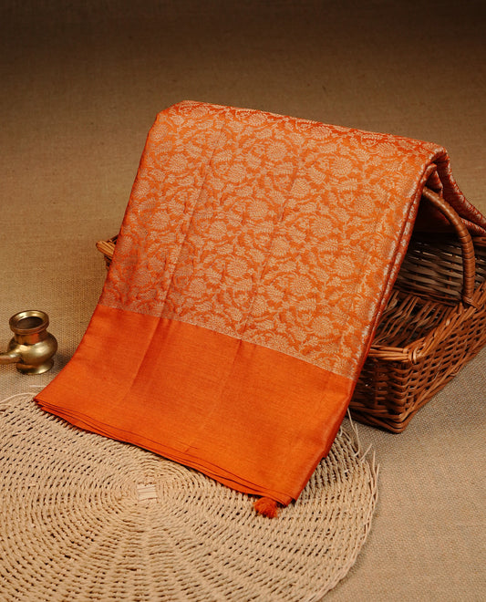 Burnt Orange  colour pure tussar silk saree featuring Light gold zari floral kodi work on the body, a plain border, grand pallu, Paired With  a matching blouse piece.