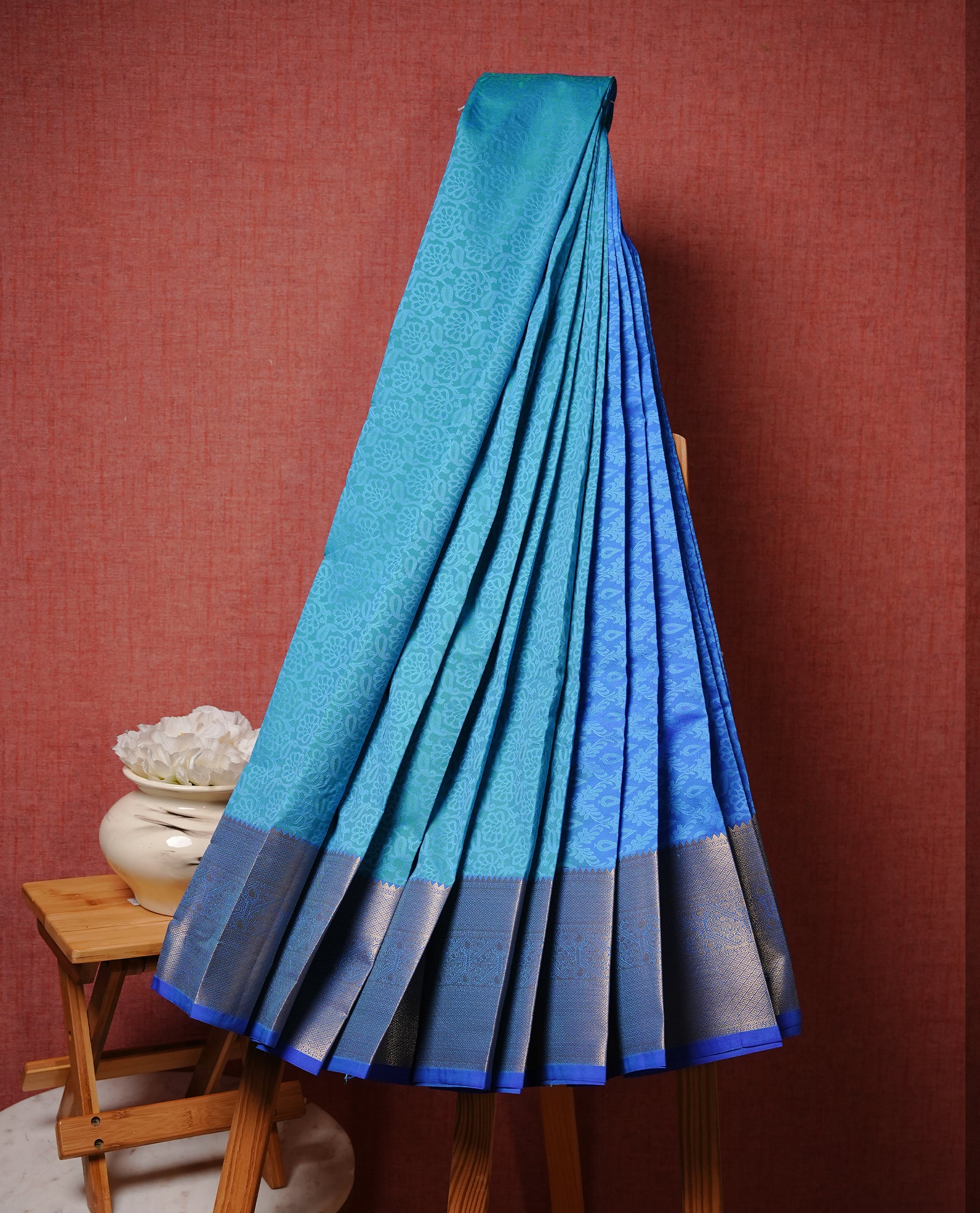 Neon blue colour Semi silk saree Featuring Self colour zari pattern on body, complemented by contrast blue colour with gold zari border, paired with matching blouse piece.