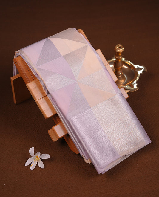 Lavender & cream colour semi soft silk saree featuring a silver zari patterned body, complemented by silver zari motifes on pallu & border and a matching blouse piece.