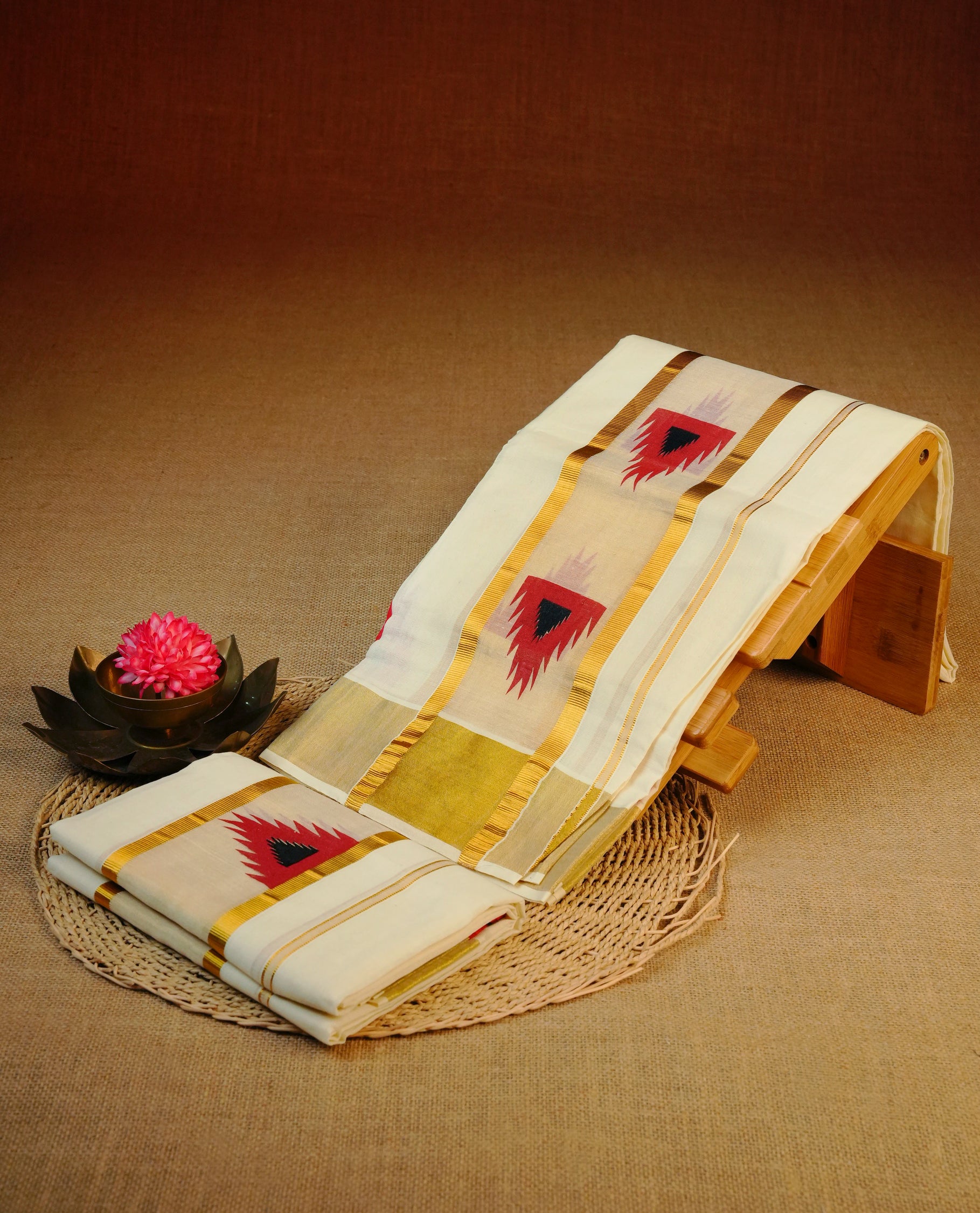 Cream colour cotton set mundu featuring simple Kasav with red temple print.