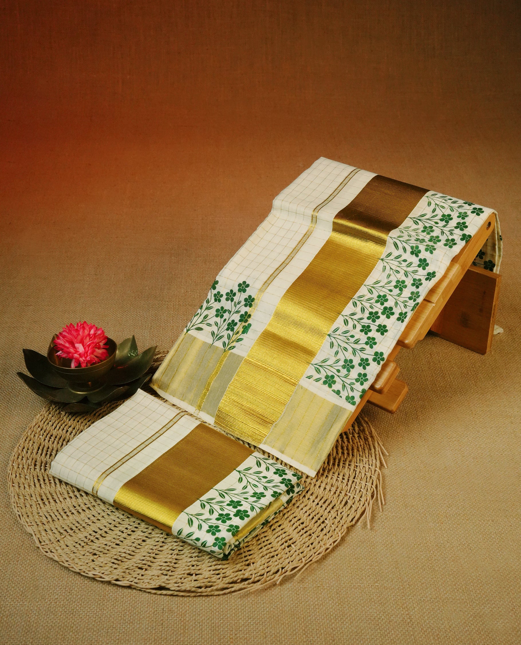 Cream colour cotton Set Mundu With gold zari check body, enhanced with Gold kasavu & Green colour floral print kara.